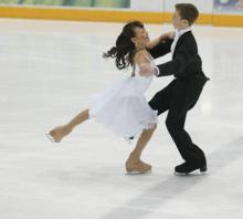 A pair of ice skaters dancing.